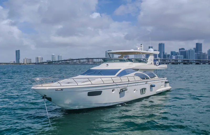 Slide: The Image of 2008 Azimut Flybridge yacht on water with city skyline in background. - 10