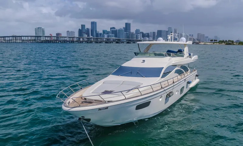 Slide: The Image of 2008 Azimut Flybridge yacht on water with city skyline in background. - 11