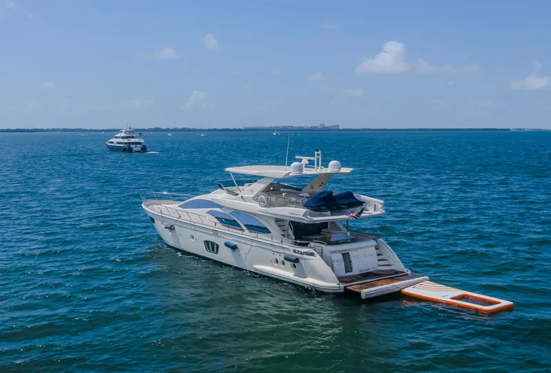 Slide: The Image of 2008 Azimut Flybridge yacht on open sea with clear blue skies. - 12