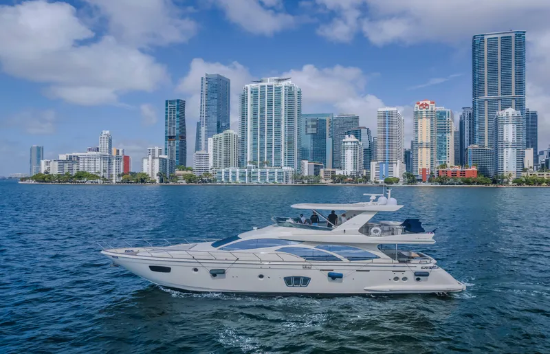 Slide: The Image of Azimut Flybridge 2008 yacht cruising near a city skyline with skyscrapers. - 19