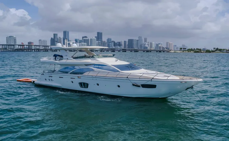 Slide: The Image of 2008 Azimut Flybridge yacht on water with city skyline in background. - 2