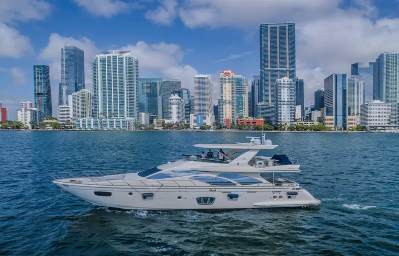 Slide: The Image of Azimut Flybridge 2008 yacht cruising near a city skyline on a sunny day. - 20