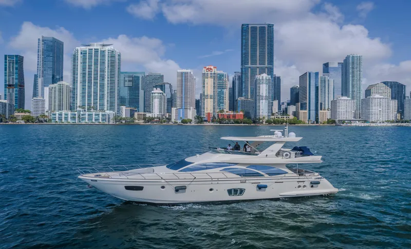 Slide: The Image of 2008 Azimut Flybridge yacht cruising near a city skyline on a sunny day. - 21
