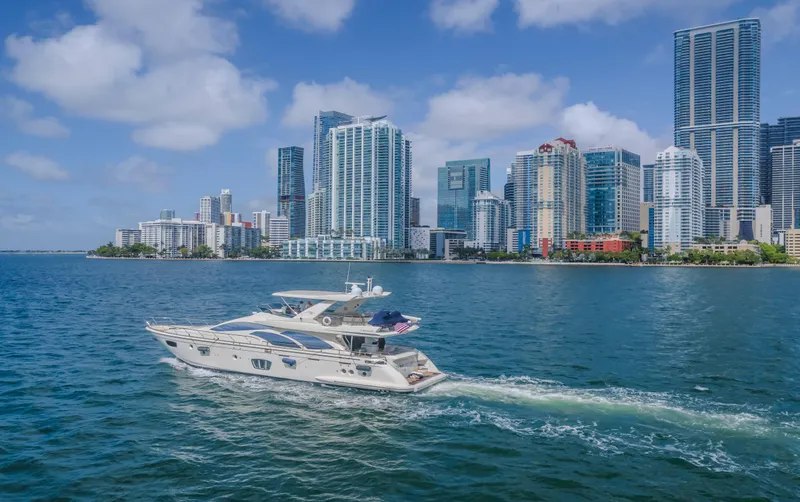 Slide: The Image of Azimut Flybridge 2008 yacht cruising near a city skyline on a sunny day. - 23