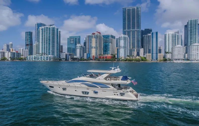 Slide: The Image of 2008 Azimut Flybridge yacht cruising near a city skyline with modern skyscrapers. - 24