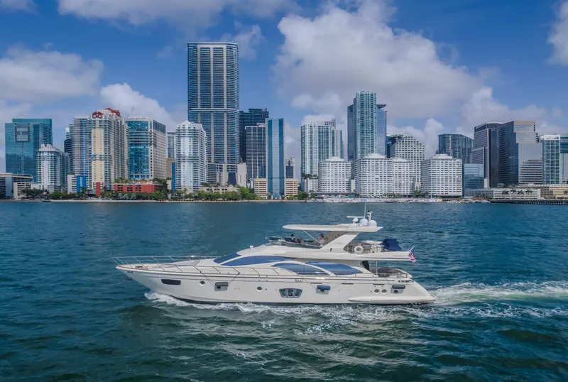 Slide: The Image of 2008 Azimut Flybridge yacht cruising near a city skyline with modern skyscrapers. - 25