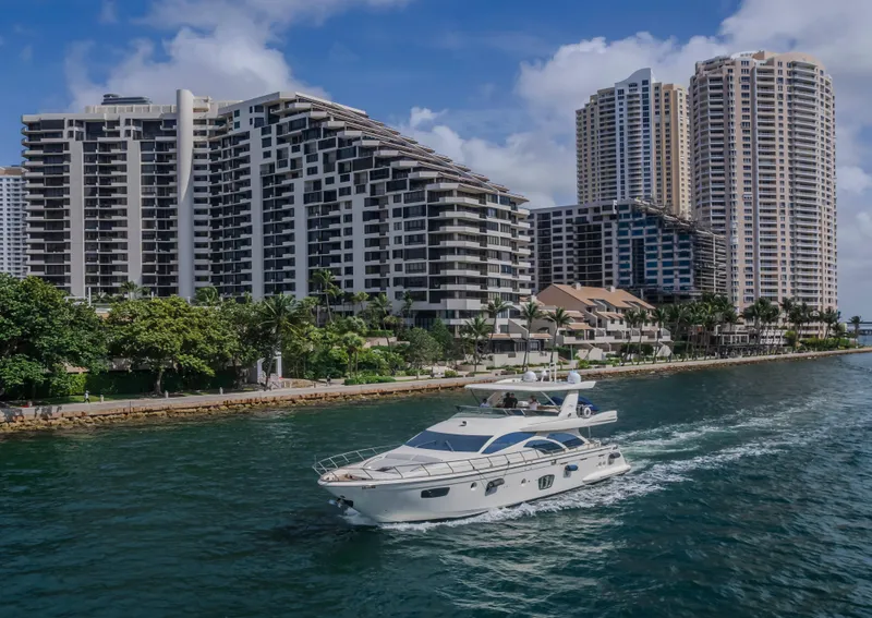 Slide: The Image of Luxury 2008 Azimut Flybridge yacht cruising near modern waterfront buildings. - 33