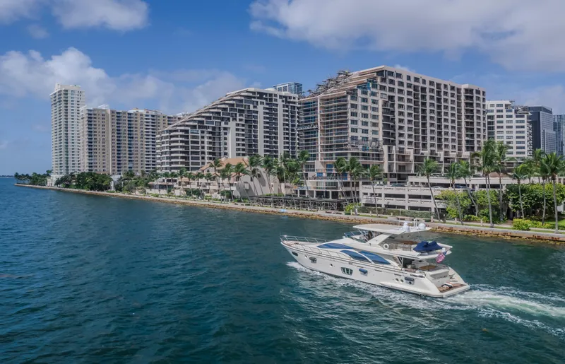 Slide: The Image of 2008 Azimut Flybridge yacht cruising near waterfront cityscape with modern high-rise buildings. - 36