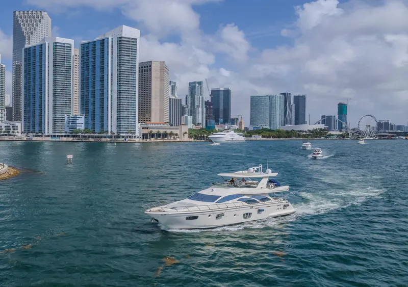 Slide: The Image of 2008 Azimut Flybridge yacht cruising near city skyline with skyscrapers and Ferris wheel. - 37