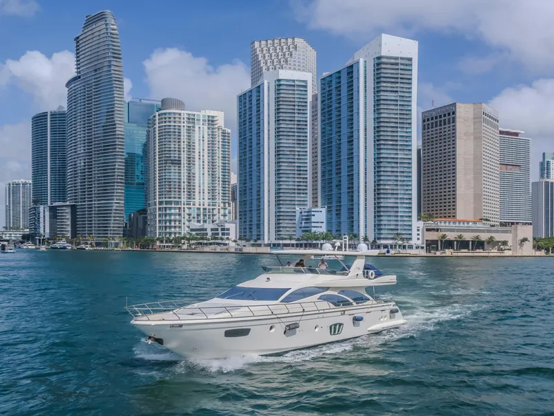 Slide: The Image of Azimut Flybridge 2008 yacht cruising near modern city skyline, blue sky, and water. - 38