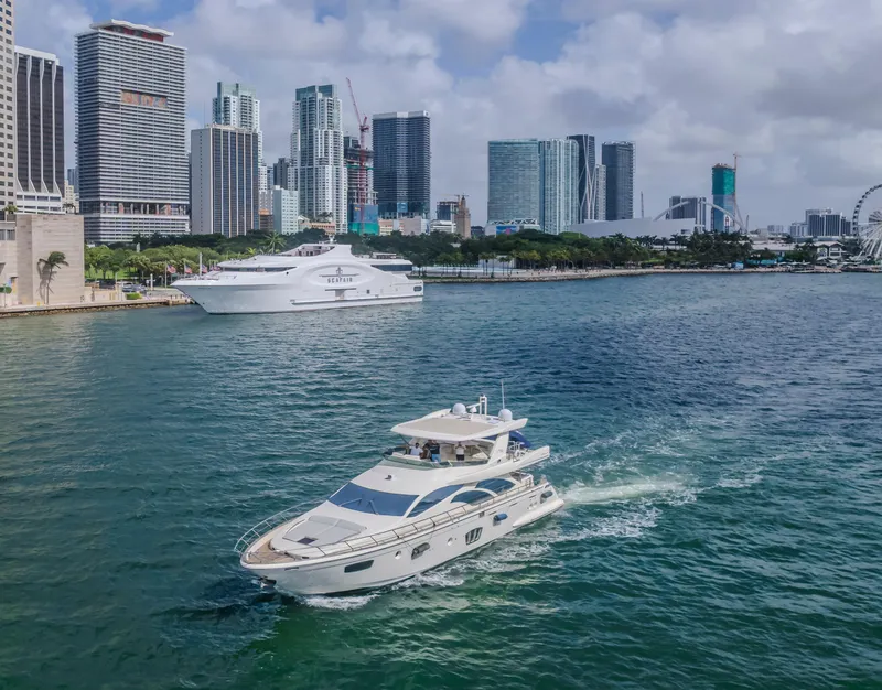 Slide: The Image of 2008 Azimut Flybridge yacht cruising in urban waterfront with city skyline backdrop. - 44