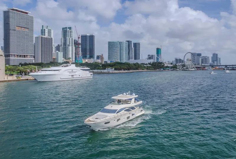 Slide: The Image of 2008 Azimut Flybridge yacht cruising near city skyline and ferris wheel. - 45