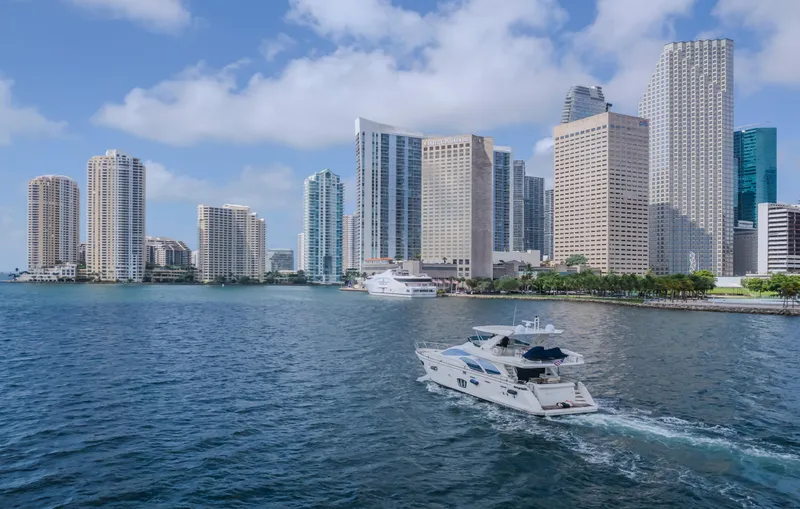 Slide: The Image of Azimut Flybridge 2008 yacht cruising near city skyline with skyscrapers and blue sky. - 47