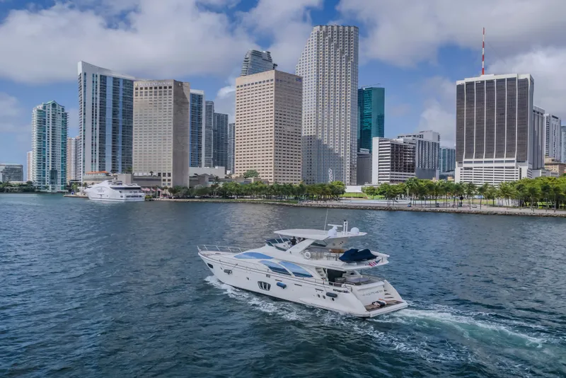 Slide: The Image of 2008 Azimut Flybridge yacht cruising near city skyline with modern skyscrapers. - 48