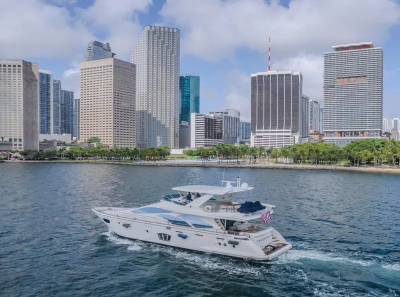 Slide: The Image of 2008 Azimut Flybridge yacht cruising near city skyline with skyscrapers and waterfront. - 49