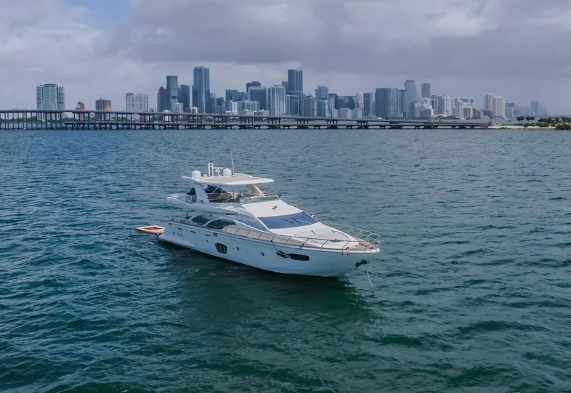 Slide: The Image of Luxury 2008 Azimut Flybridge yacht on water with city skyline backdrop. - 9