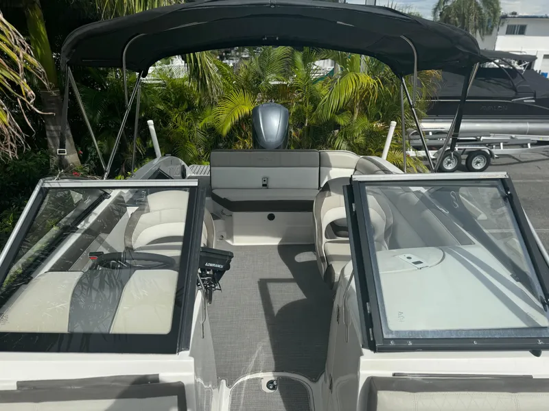 Slide: The Image of 2017 Starcraft 230 OB SCX EXT boat interior with seating and canopy. - 14