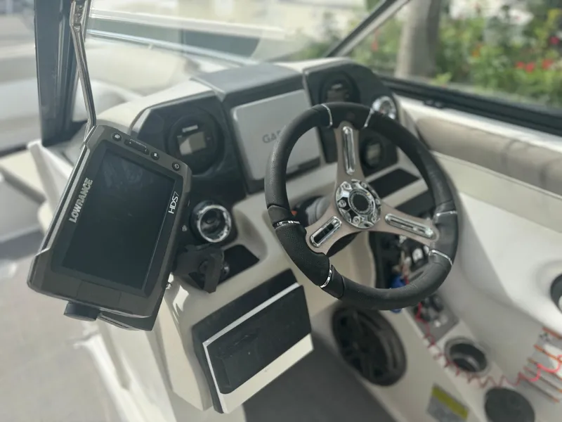 Slide: The Image of Steering wheel and controls of 2017 Starcraft 230 OB SCX EXT boat with Lowrance HDS7 display. - 18