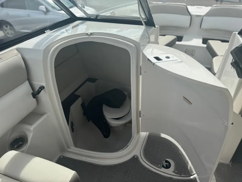 Slide: The Image of 2017 Starcraft 230 OB SCX EXT boat interior with open cabin door and seating. - 21