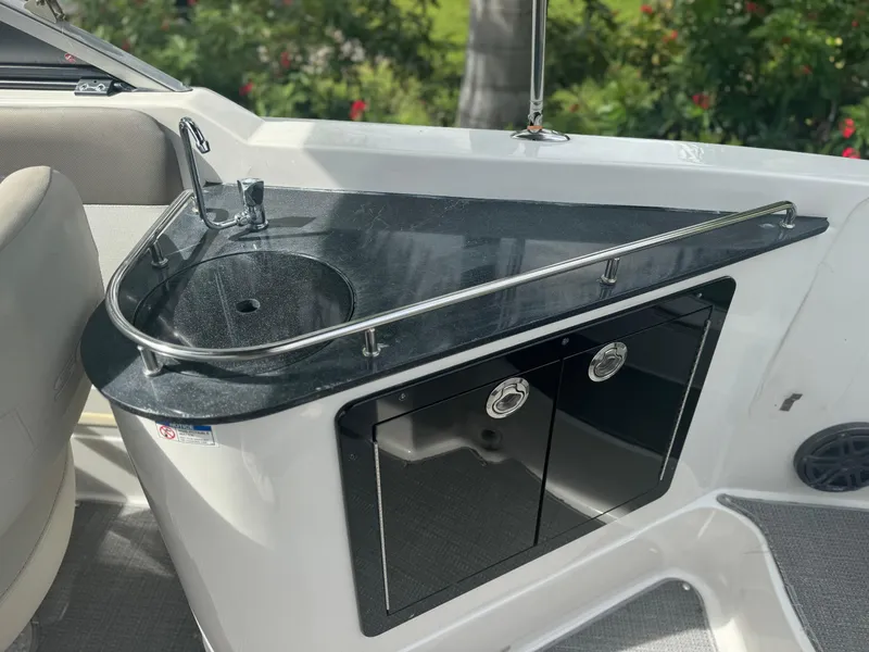 Slide: The Image of 2017 Starcraft 230 OB SCX EXT boat sink and counter with storage cabinets. - 23