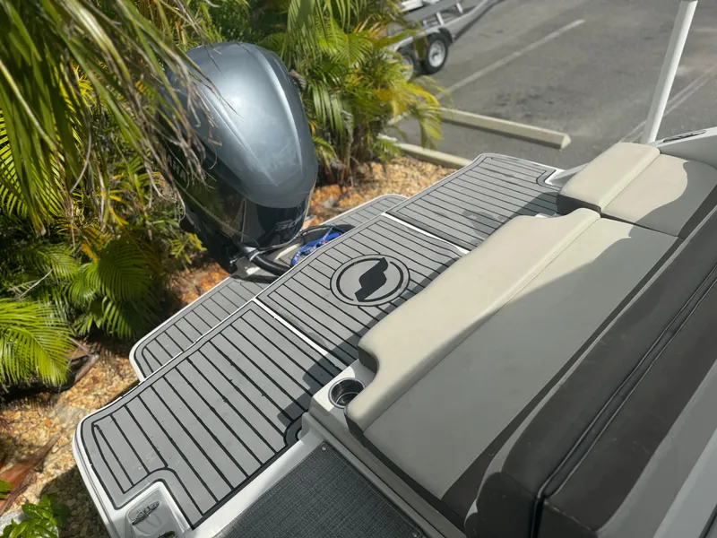 Slide: The Image of 2017 Starcraft 230 OB SCX EXT boat with outboard motor and cushioned seating. - 25