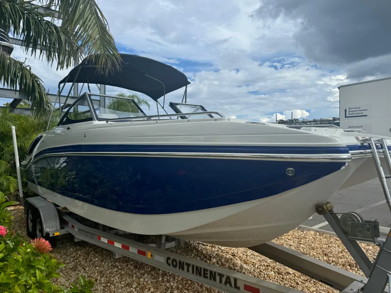 Slide: The Image of 2017 Starcraft 230 OB SCX EXT boat on trailer, parked outdoors under cloudy sky. - 6