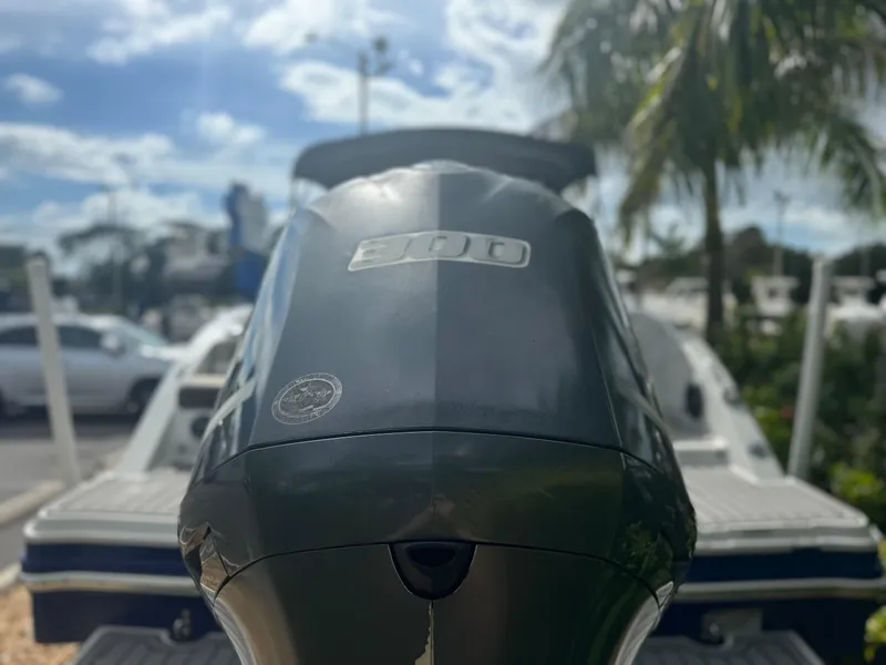 Slide: The Image of 2017 Starcraft 230 OB SCX EXT boat engine close-up with palm trees in background. - 8