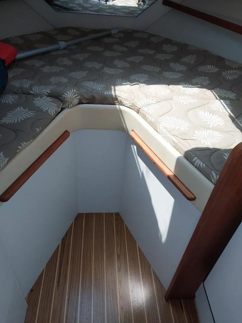 Slide: The Image of 2006 Tiara Yachts 2900 Coronet cabin interior with patterned cushions and wood accents. - 10