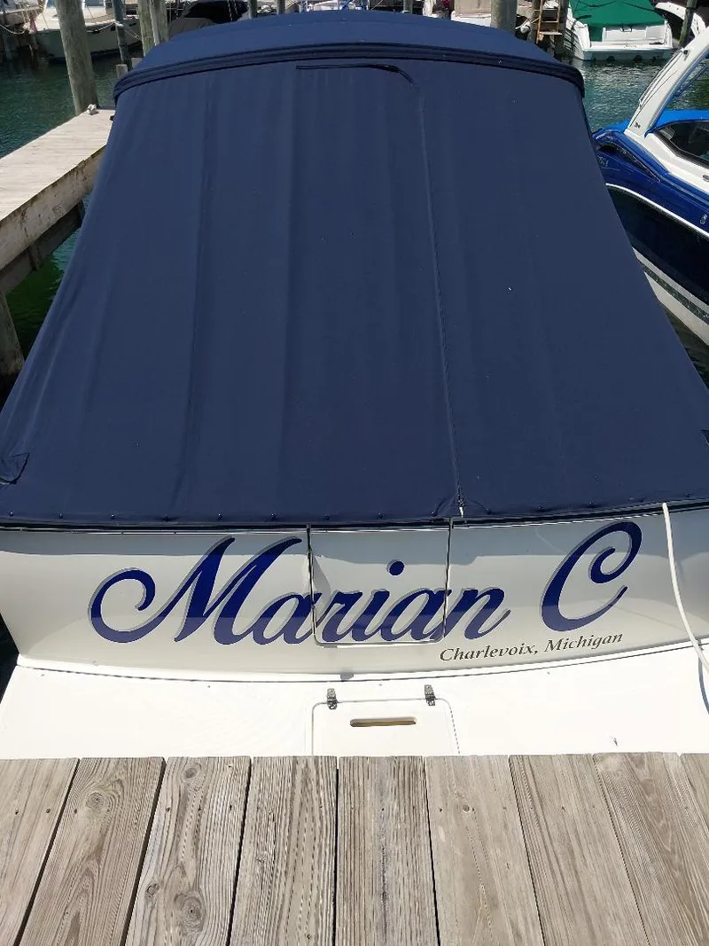 Slide: The Image of 2006 Tiara Yachts 2900 Coronet docked, covered, with "Marian C" name visible. - 2