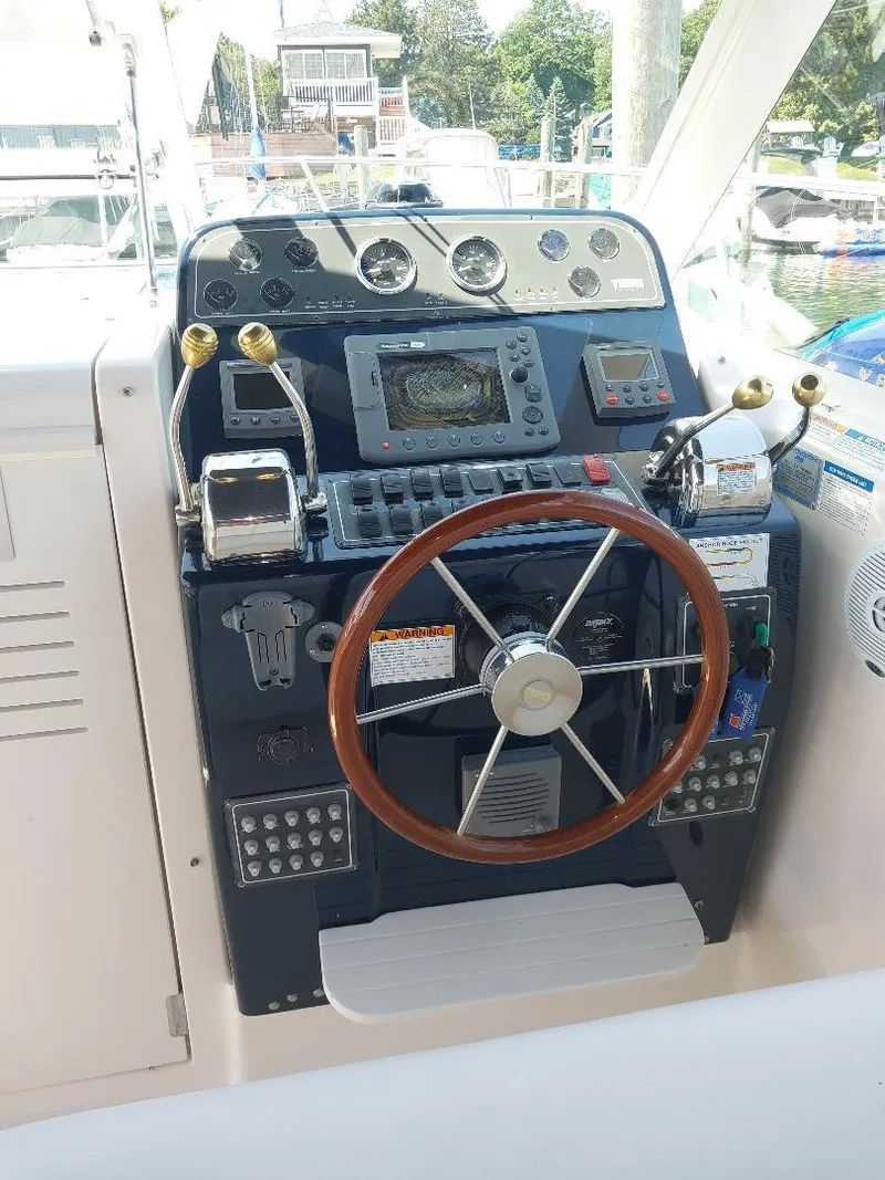 Slide: The Image of Helm of 2006 Tiara Yachts 2900 Coronet with steering wheel and navigation controls. - 4