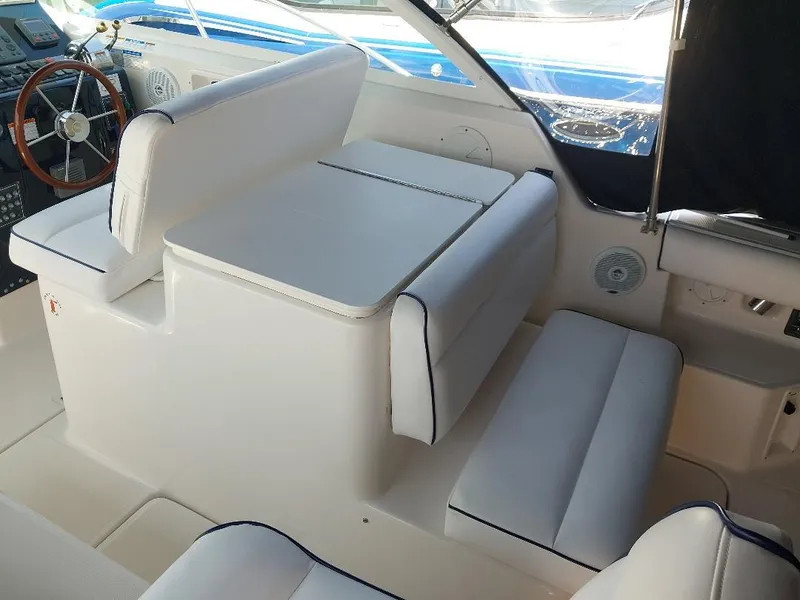 Slide: The Image of 2006 Tiara Yachts 2900 Coronet interior with white seating and steering wheel. - 5