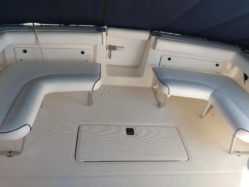 Slide: The Image of 2006 Tiara Yachts 2900 Coronet interior seating area with white cushioned benches. - 6