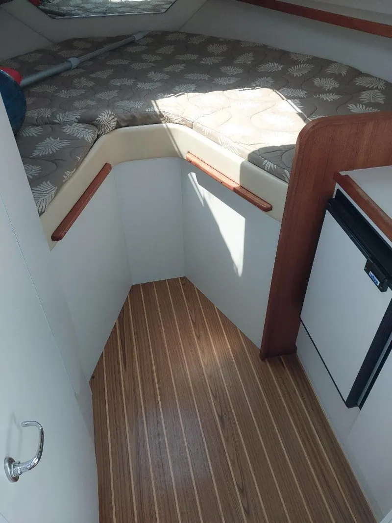 Slide: The Image of 2006 Tiara Yachts 2900 Coronet cabin interior with bed and wooden flooring. - 9