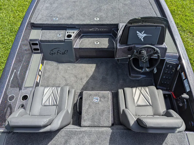 Slide: The Image of 2026 Falcon F215 boat interior with dual seats, steering console, and "Go Fish!" storage compartment. - 10