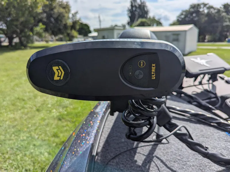 Slide: The Image of Trolling motor on Falcon F215 boat, 2026 model, in a grassy outdoor setting. - 15