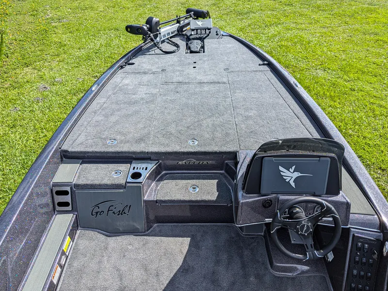 Slide: The Image of 2026 Falcon F215 boat interior with steering wheel and "Go Fish!" inscription. - 8