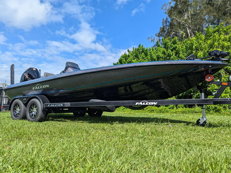 Slide: The Image of 2026 Falcon F215 boat on trailer, parked on grass under blue sky. - 3