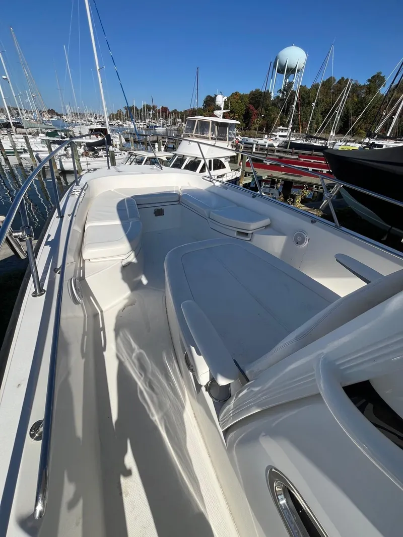 Slide: The Image of 2014 Boston Whaler 270 Dauntless boat docked in marina, sunny day. - 12