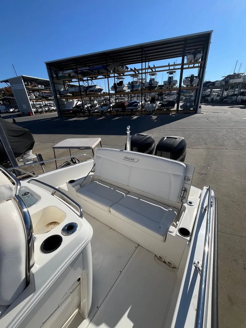 Slide: The Image of 2014 Boston Whaler 270 Dauntless boat at marina, sunny day. - 13