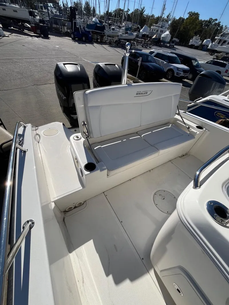 Slide: The Image of 2014 Boston Whaler 270 Dauntless boat interior with seating and storage. - 22