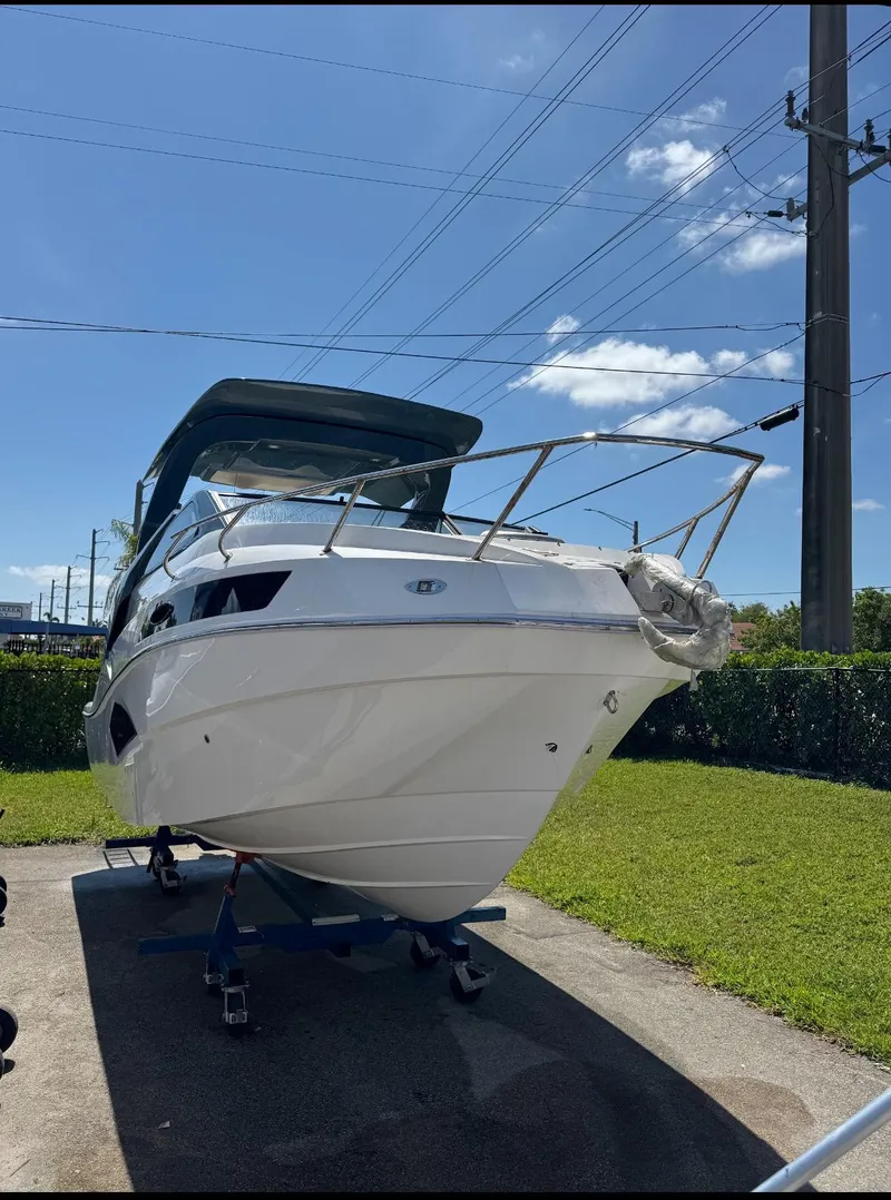 Slide: The Image of 2025 NX Boats NX290 Exclusive on trailer under clear blue sky. - 3