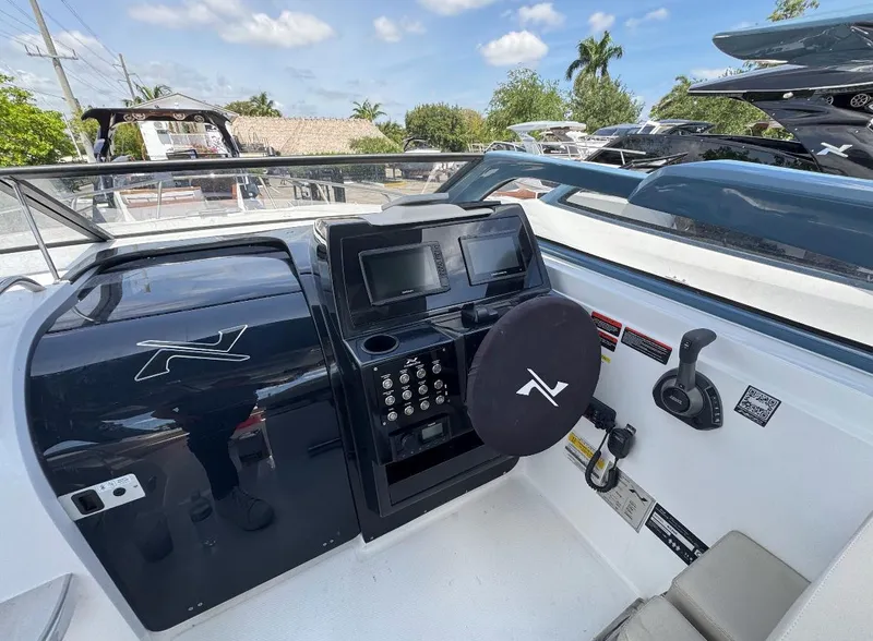 Slide: The Image of 2025 NX Boats NX290 Exclusive dashboard with steering wheel and control panel. - 4
