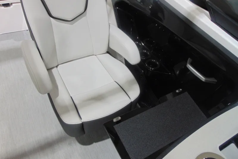 Slide: The Image of 2025 Yamaha Boats AR250 interior with white captain's chair and storage compartment. - 13