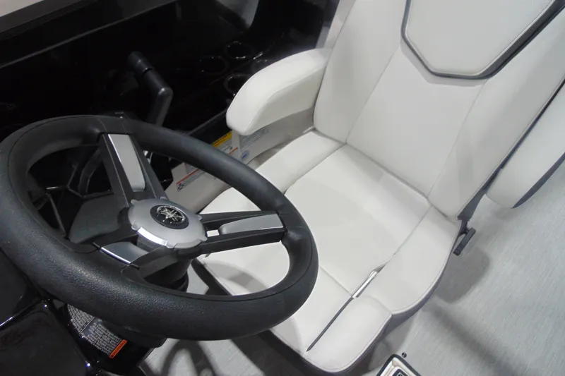 Slide: The Image of 2025 Yamaha Boats AR250 steering wheel and captain's seat, showcasing modern design. - 14