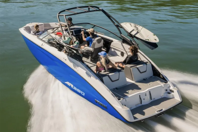 Slide: The Image of 2025 Yamaha Boats AR250 interior with seating and table, featuring modern design and amenities. - 2