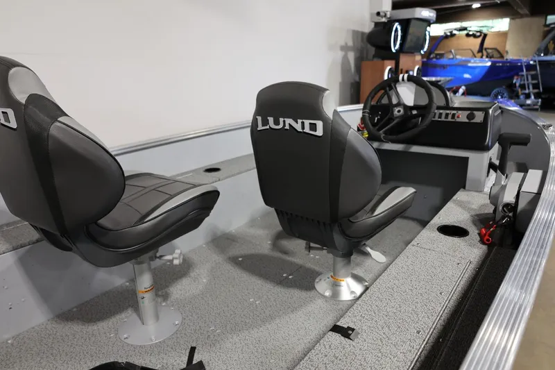 Slide: The Image of 2025 Lund 1600 Fury SS boat interior with steering console and seating. - 10