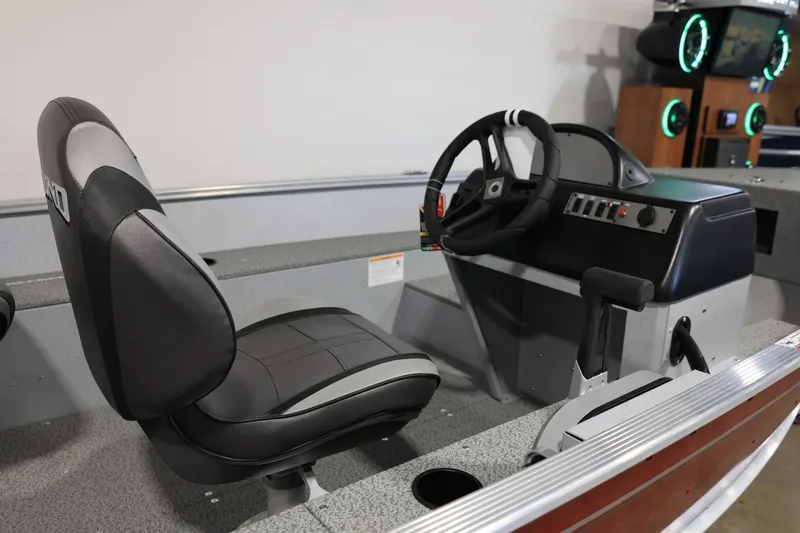 Slide: The Image of 2025 Lund 1600 Fury SS boat interior with steering wheel and seat. - 8