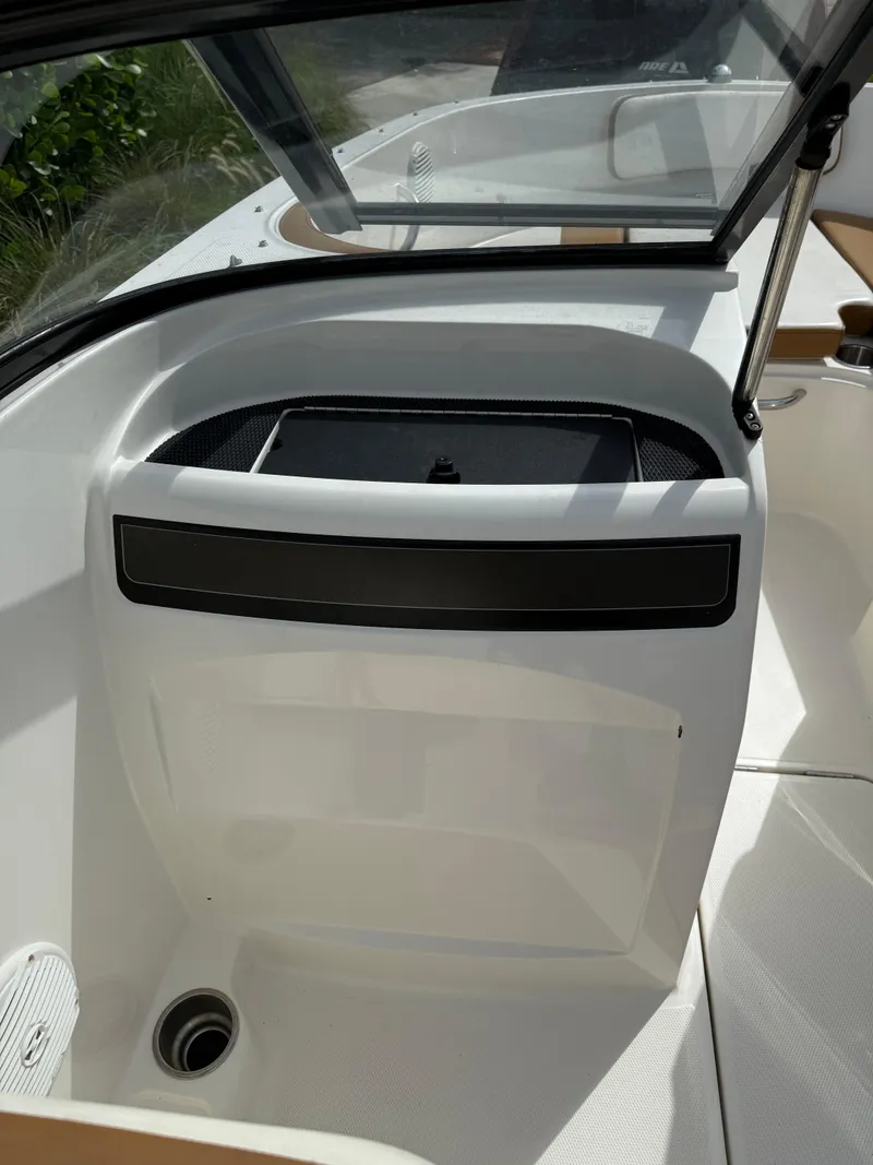 Slide: The Image of 2019 Bayliner VR4 Bowrider OB interior with open storage compartment and sleek design. - 10