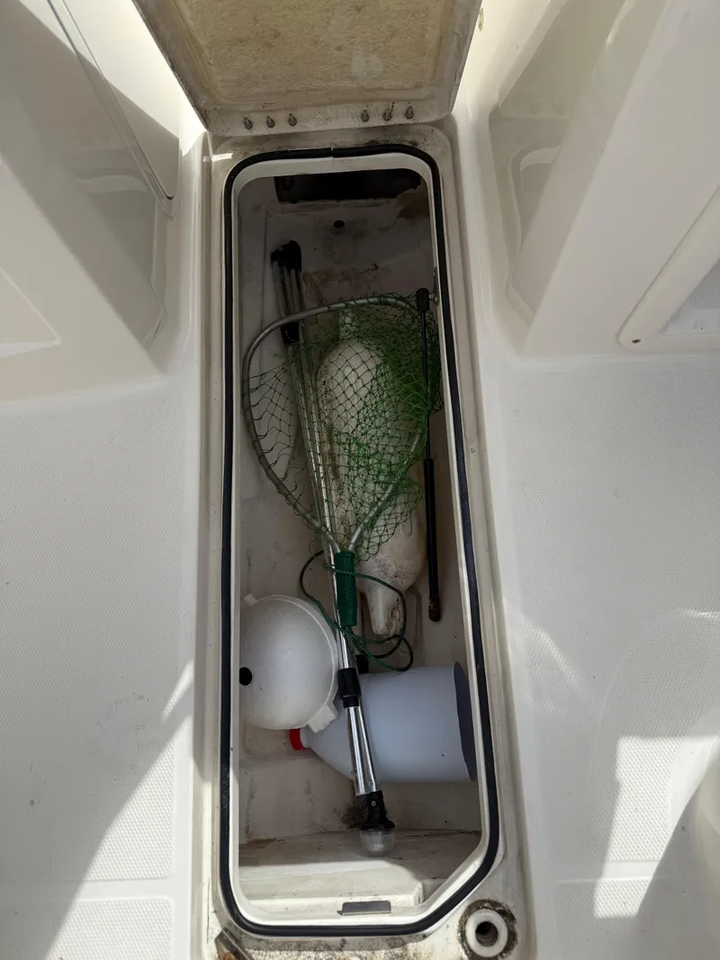 Slide: The Image of 2019 Bayliner VR4 Bowrider OB storage compartment with fishing gear and equipment. - 11