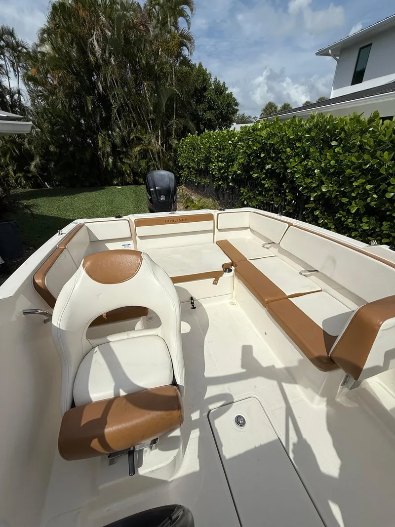 Slide: The Image of 2019 Bayliner VR4 Bowrider OB with brown and white seating, parked outdoors. - 15
